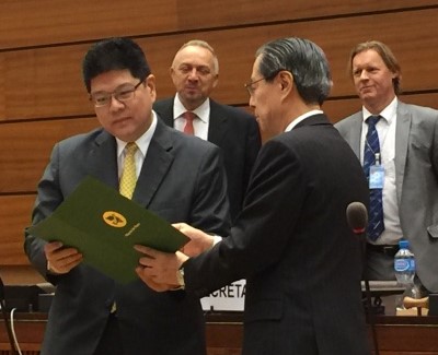Yasuyoshi Komizo, Secretary-General of Mayors for Peace, presents the Open Letter to Ambassador Thani