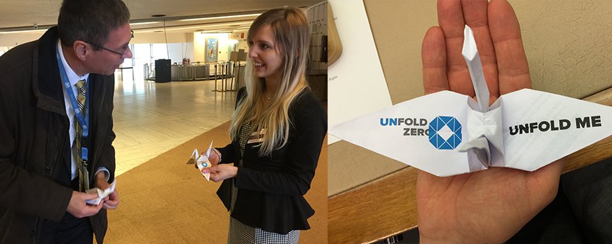 Caroline Regina Schlunke of UNFOLD ZERO gives an origami crane to Ambassador Thomas Hajnoczi of Austria